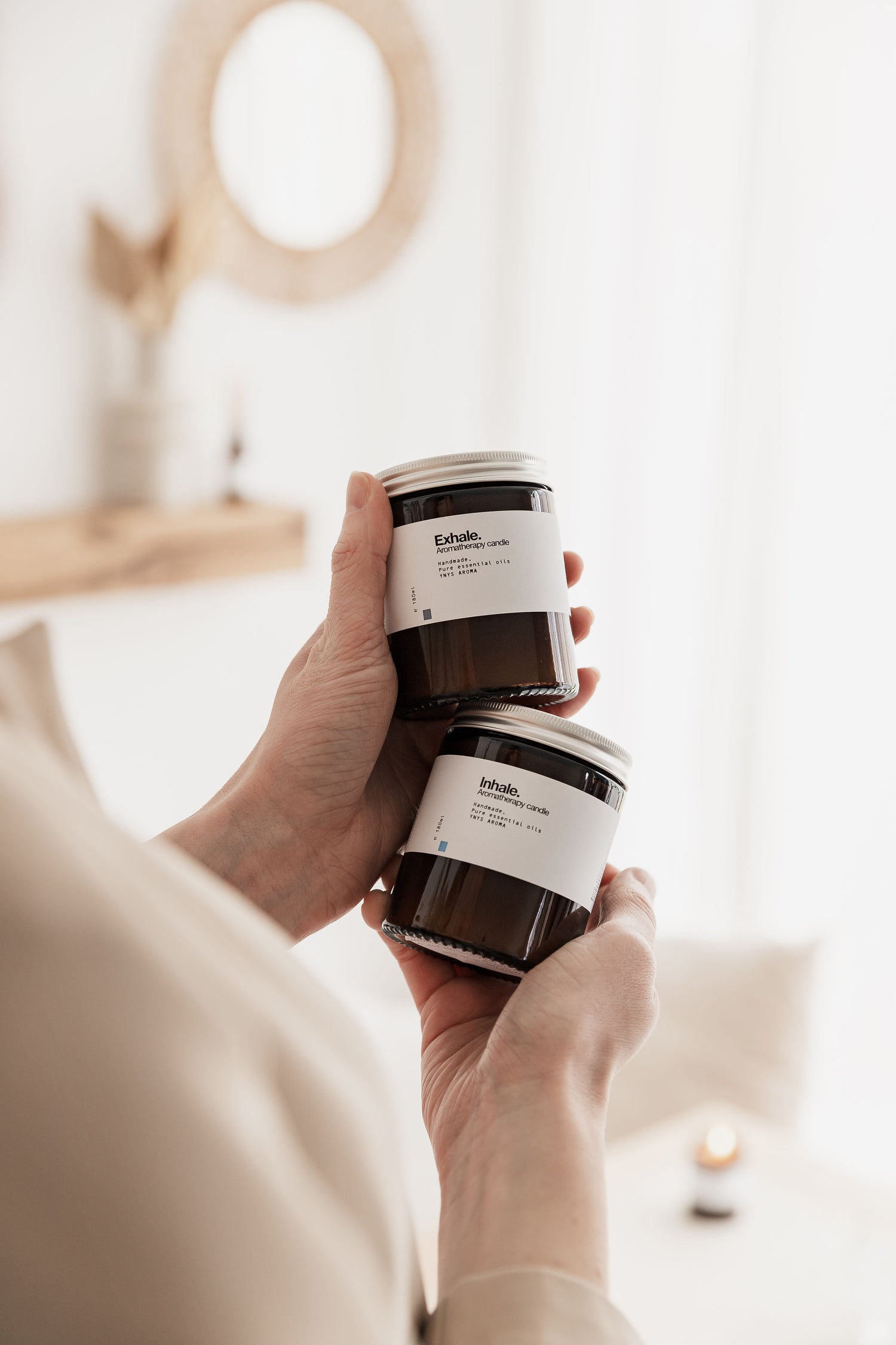 Two aromatherapy candles in amber glass jars