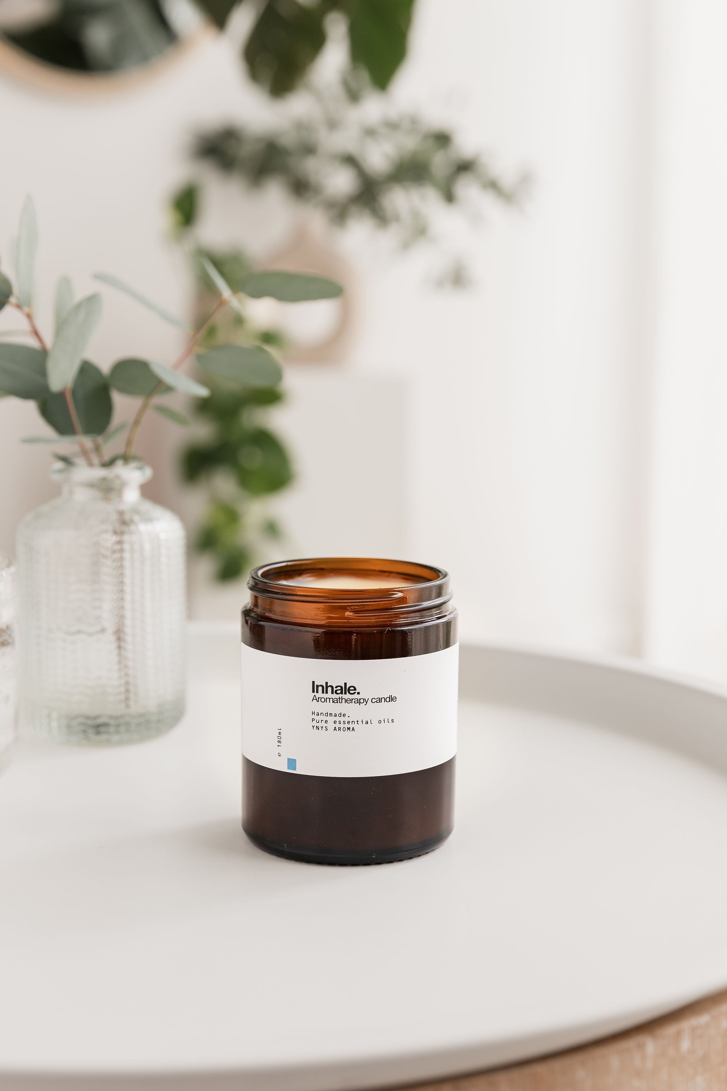 Two aromatherapy candles in amber glass jars